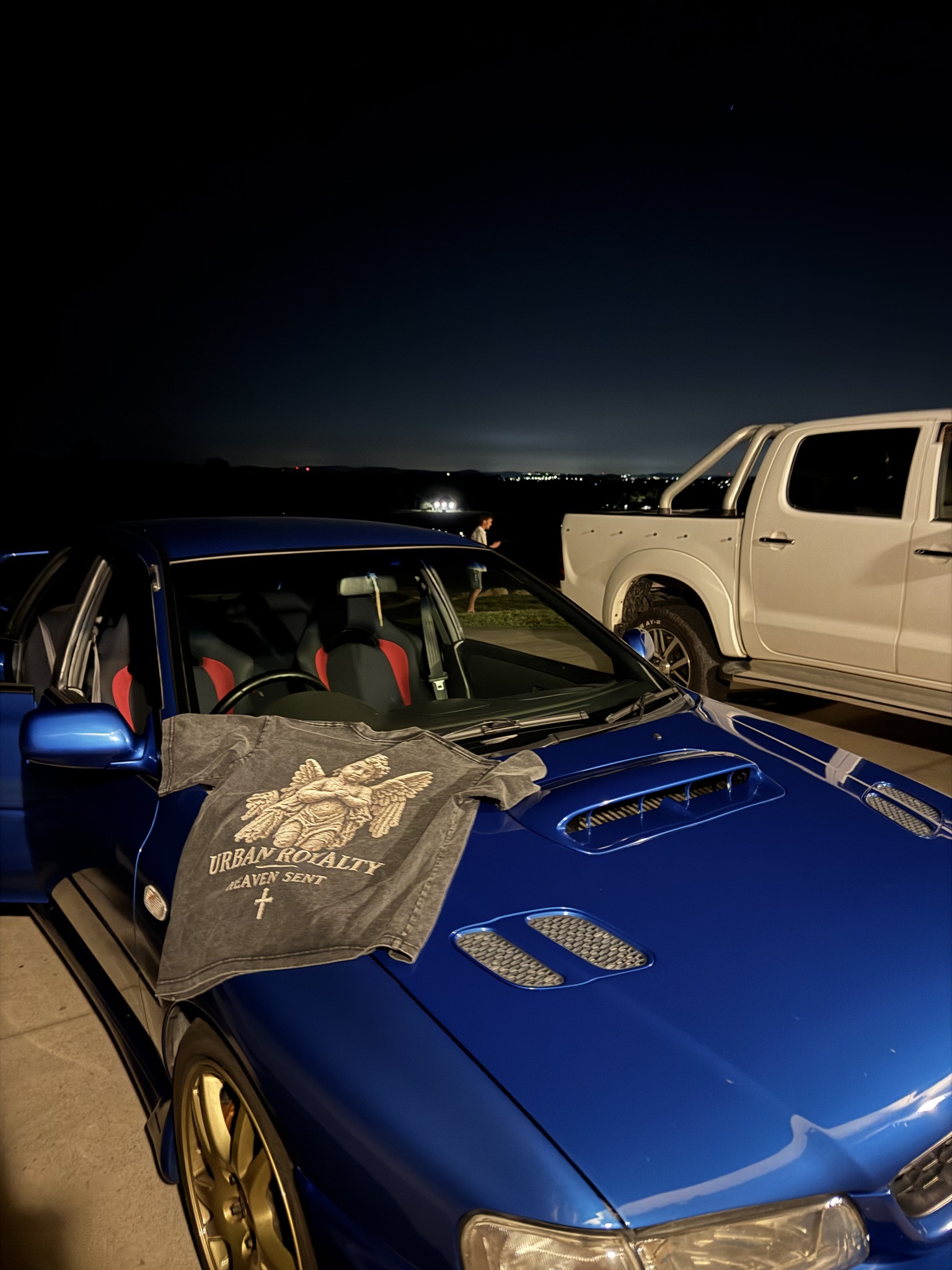 Urban Royalty Heaven Sent campaign photo on a blue car at night